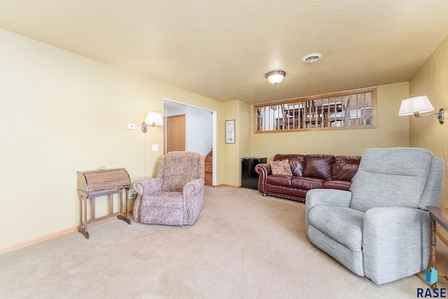 living room featuring carpet and a textured ceiling