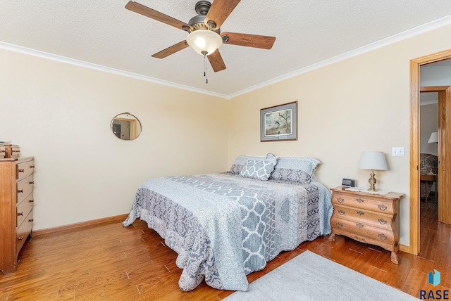 bedroom with ceiling fan, crown molding, and wood-type flooring