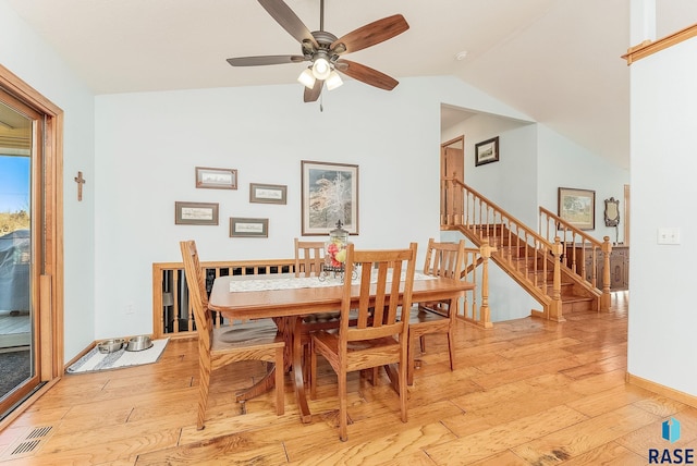 dining room featuring ceiling fan, lofted ceiling, and light wood-type flooring