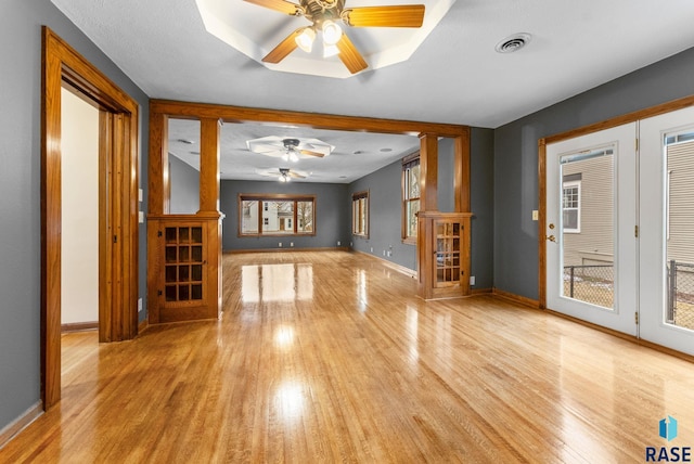 unfurnished living room featuring ceiling fan and light wood-type flooring