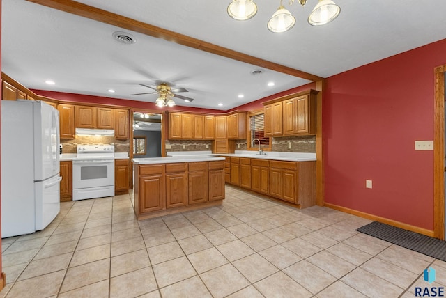 kitchen with white appliances, a kitchen island, ceiling fan, and backsplash