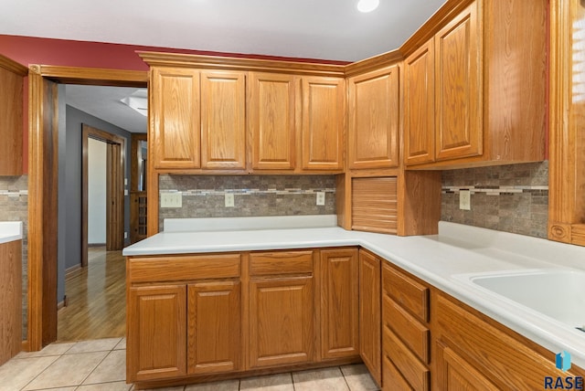 kitchen with sink, tasteful backsplash, and light tile patterned flooring