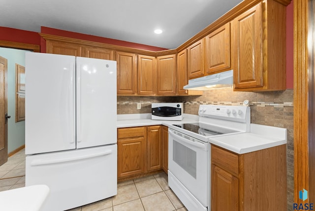 kitchen with white appliances, backsplash, and light tile patterned floors