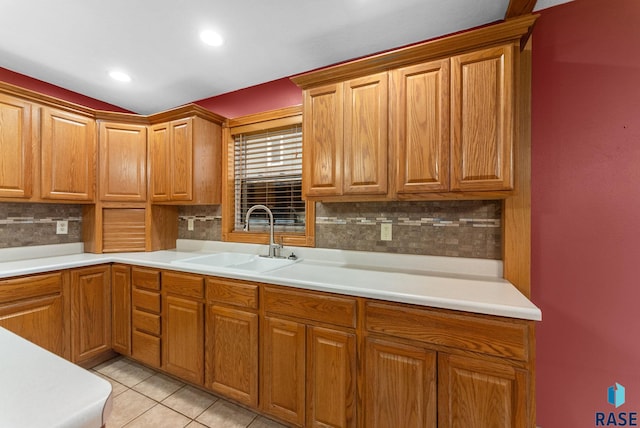 kitchen featuring light tile patterned floors, tasteful backsplash, and sink