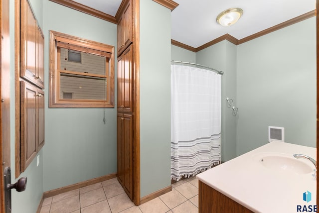 bathroom with tile patterned floors, vanity, and crown molding