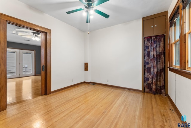 unfurnished room with french doors, light hardwood / wood-style flooring, plenty of natural light, and ceiling fan