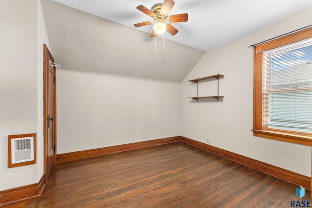 additional living space featuring heating unit, dark hardwood / wood-style floors, ceiling fan, and lofted ceiling