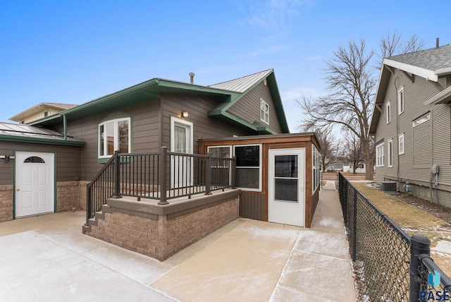 rear view of house featuring a patio area and central AC unit