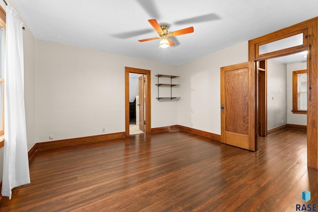 unfurnished bedroom featuring ceiling fan and dark wood-type flooring