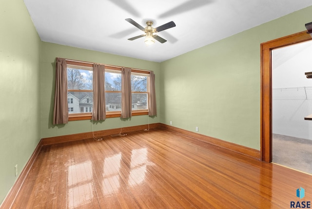 empty room featuring ceiling fan and hardwood / wood-style flooring