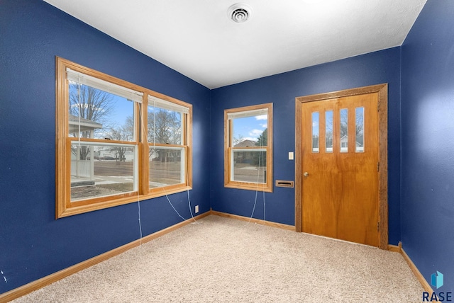 foyer featuring carpet flooring