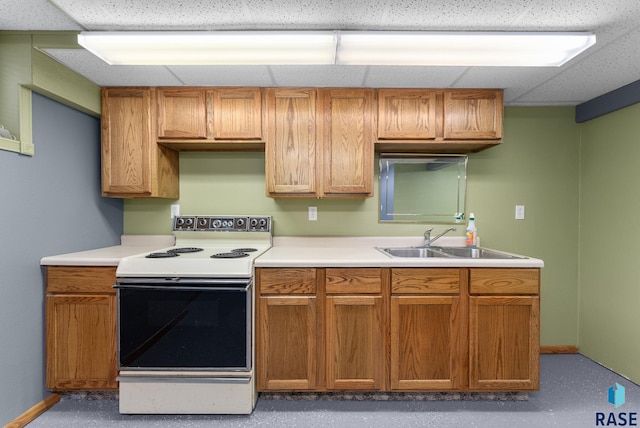 kitchen with a drop ceiling, white electric range, and sink