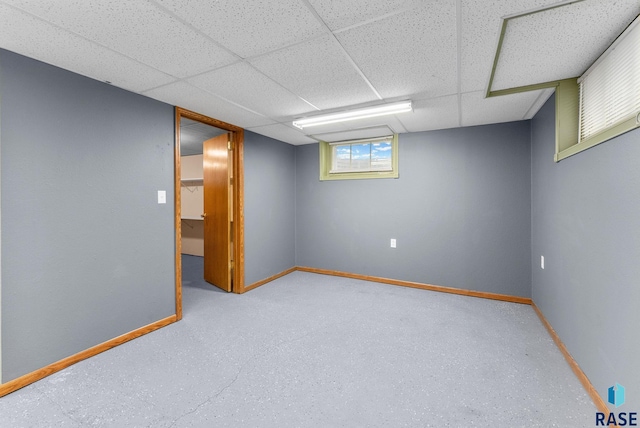 basement with a paneled ceiling