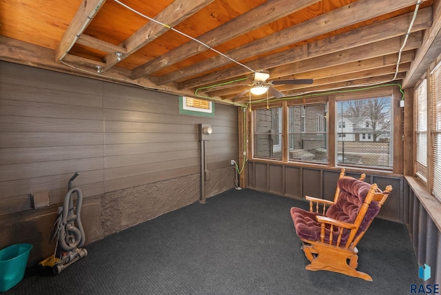 unfurnished sunroom featuring ceiling fan