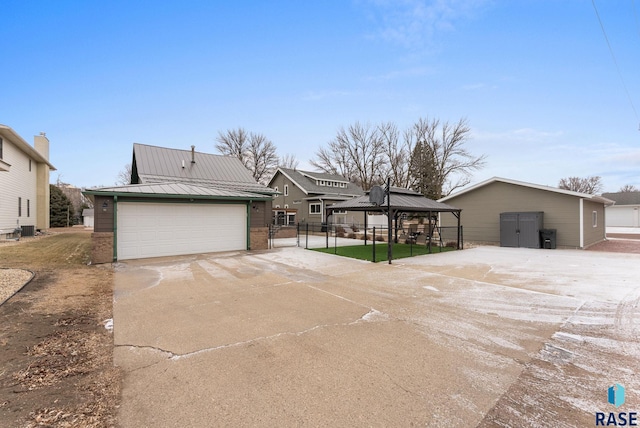 view of front of property with an outbuilding, a gazebo, central AC, and a garage