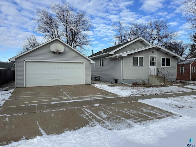 view of front of house featuring a garage and an outbuilding