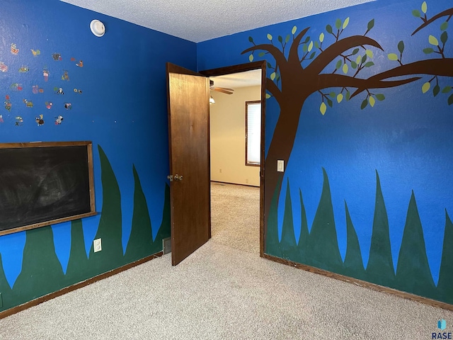 unfurnished bedroom featuring carpet flooring and a textured ceiling