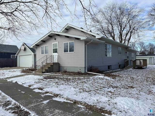 view of front of property featuring a garage and an outdoor structure