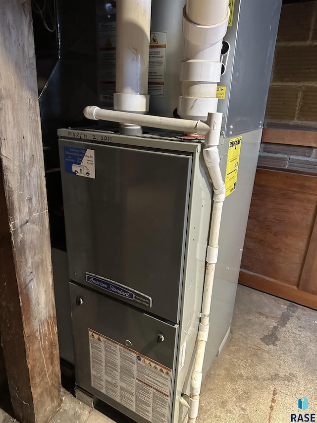 utility room featuring heating unit