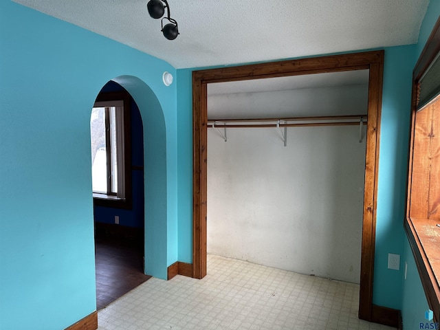 unfurnished bedroom featuring a closet and a textured ceiling