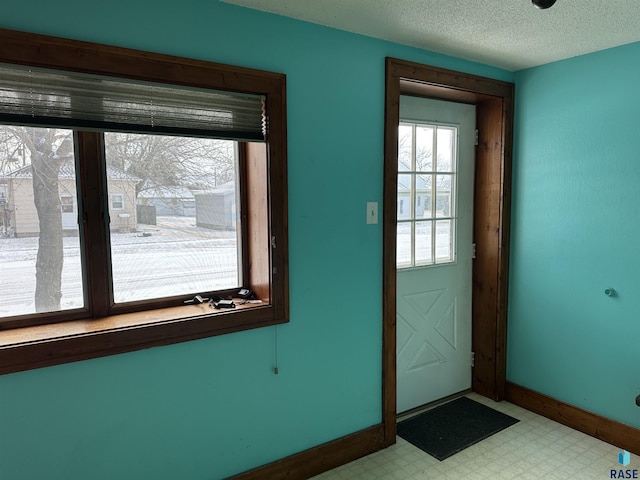 entryway featuring a textured ceiling