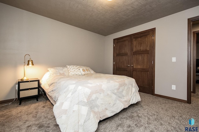 carpeted bedroom featuring a textured ceiling