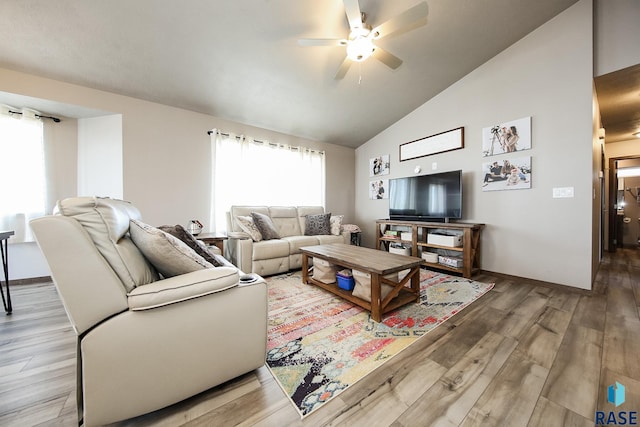 living room with vaulted ceiling, hardwood / wood-style floors, and ceiling fan