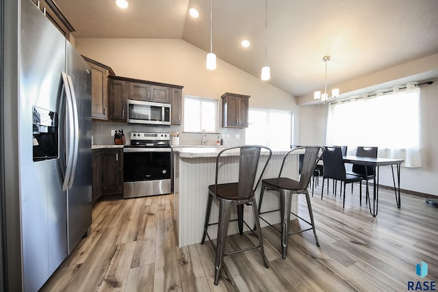 kitchen featuring appliances with stainless steel finishes, pendant lighting, and backsplash