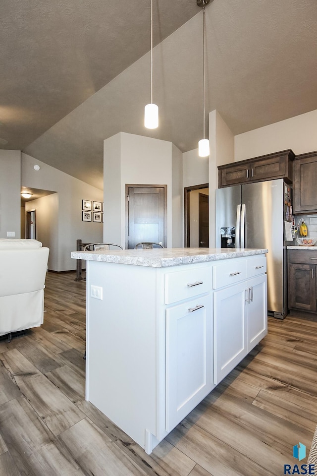 kitchen featuring pendant lighting, dark brown cabinetry, white cabinets, and stainless steel refrigerator with ice dispenser