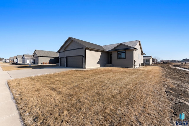 ranch-style house with a garage and a front lawn