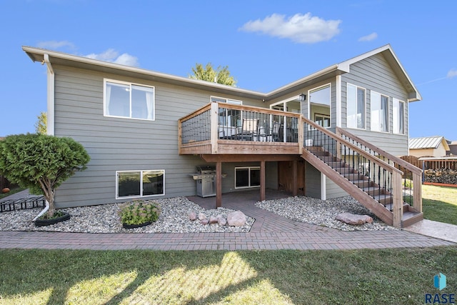 back of property with a wooden deck and a lawn