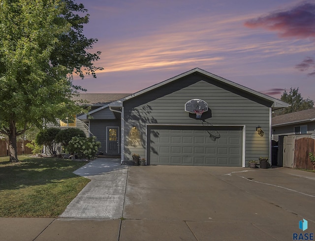 ranch-style home with a lawn and a garage