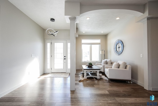 foyer featuring hardwood / wood-style floors and ornate columns