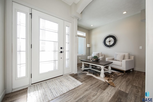 entryway featuring hardwood / wood-style floors and decorative columns