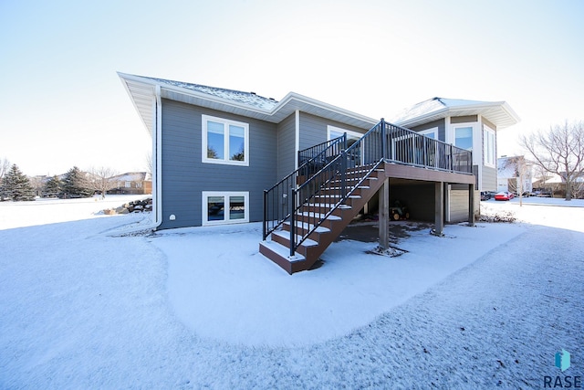 snow covered house featuring a deck