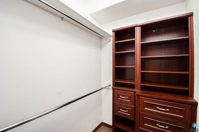 walk in closet with carpet flooring