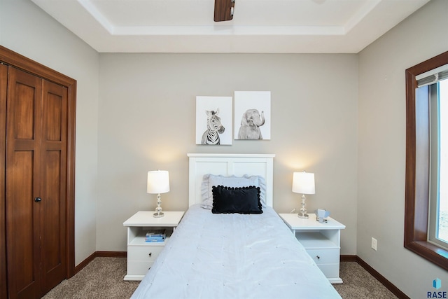 bedroom with ceiling fan and dark carpet