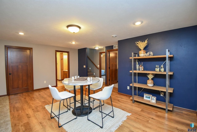 dining space with light wood-type flooring