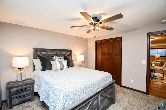 carpeted bedroom featuring ceiling fan and a closet