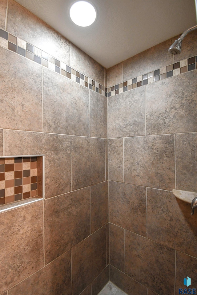 bathroom with tiled shower