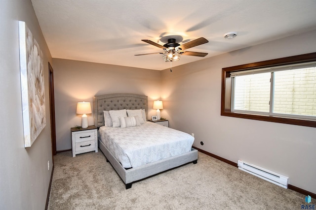 bedroom with ceiling fan, baseboard heating, and light carpet