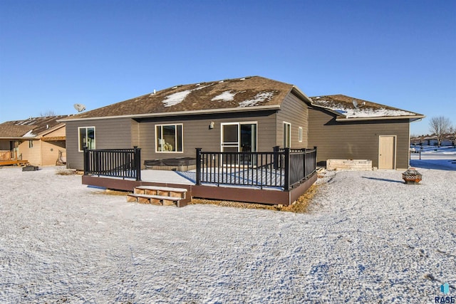 rear view of property featuring a wooden deck