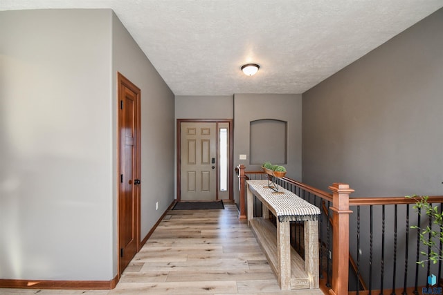 foyer featuring light hardwood / wood-style flooring and a textured ceiling