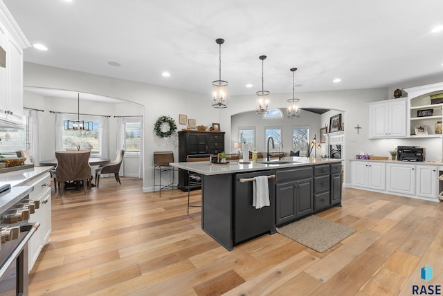 kitchen featuring stainless steel appliances, white cabinetry, a center island, and pendant lighting