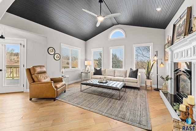 living room featuring vaulted ceiling, ceiling fan, and light hardwood / wood-style floors