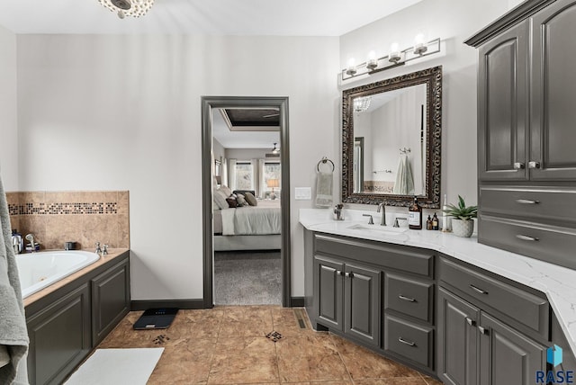 bathroom with tile patterned floors, a tub, and vanity