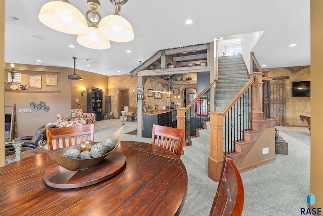 dining space with an inviting chandelier and carpet