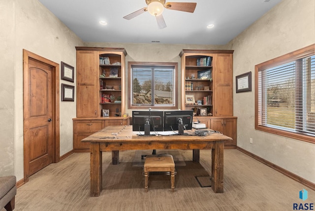 carpeted home office with ceiling fan