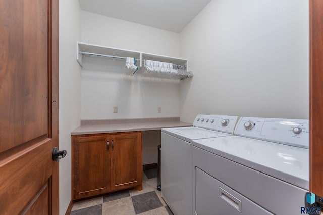 washroom featuring cabinets and separate washer and dryer