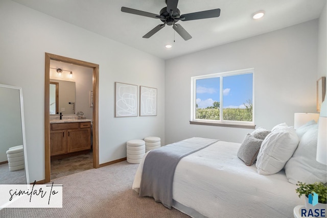 bedroom with sink, light colored carpet, ceiling fan, and connected bathroom